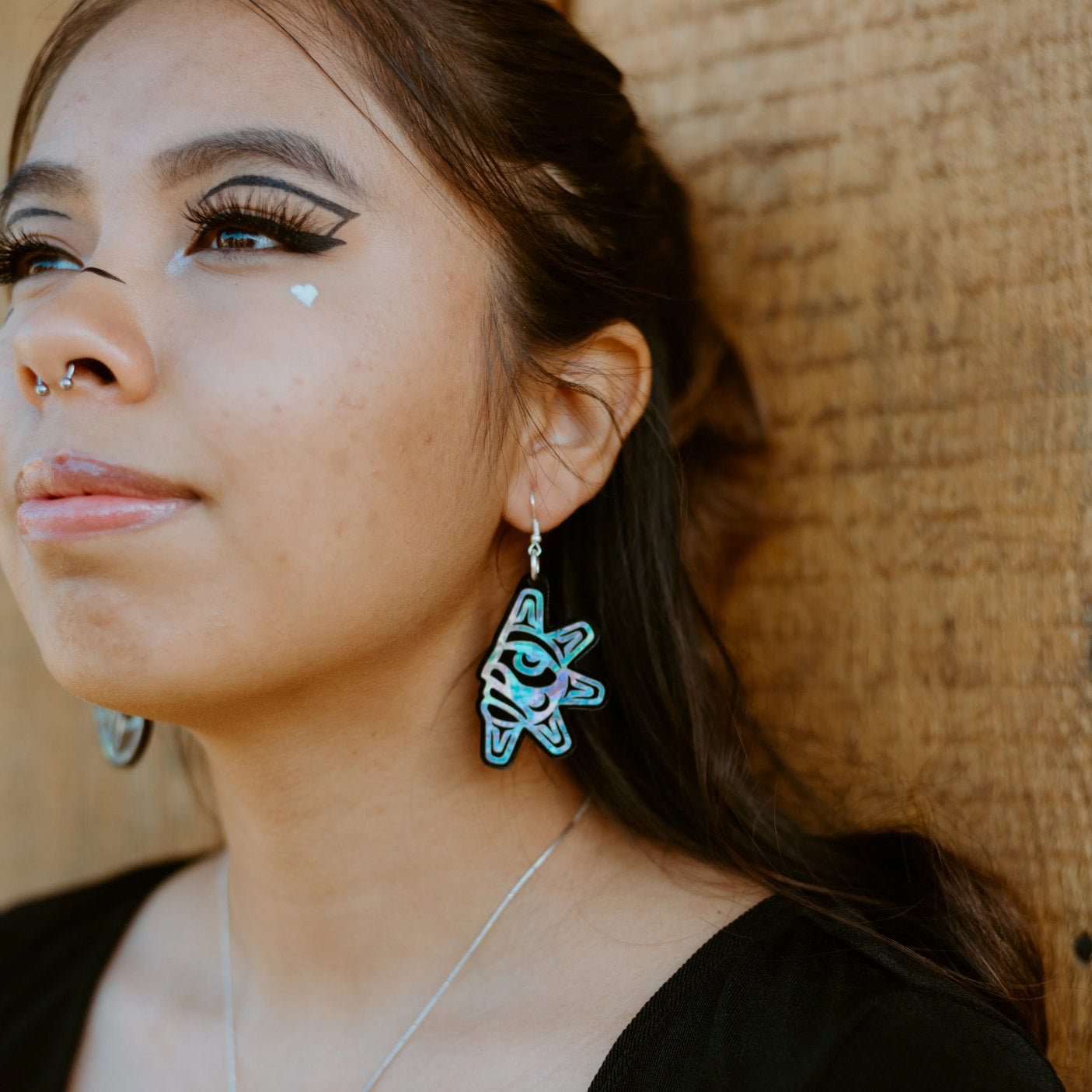 A closeup of the sun side of the "Hupal" earrings from Copper Canoe Woman.