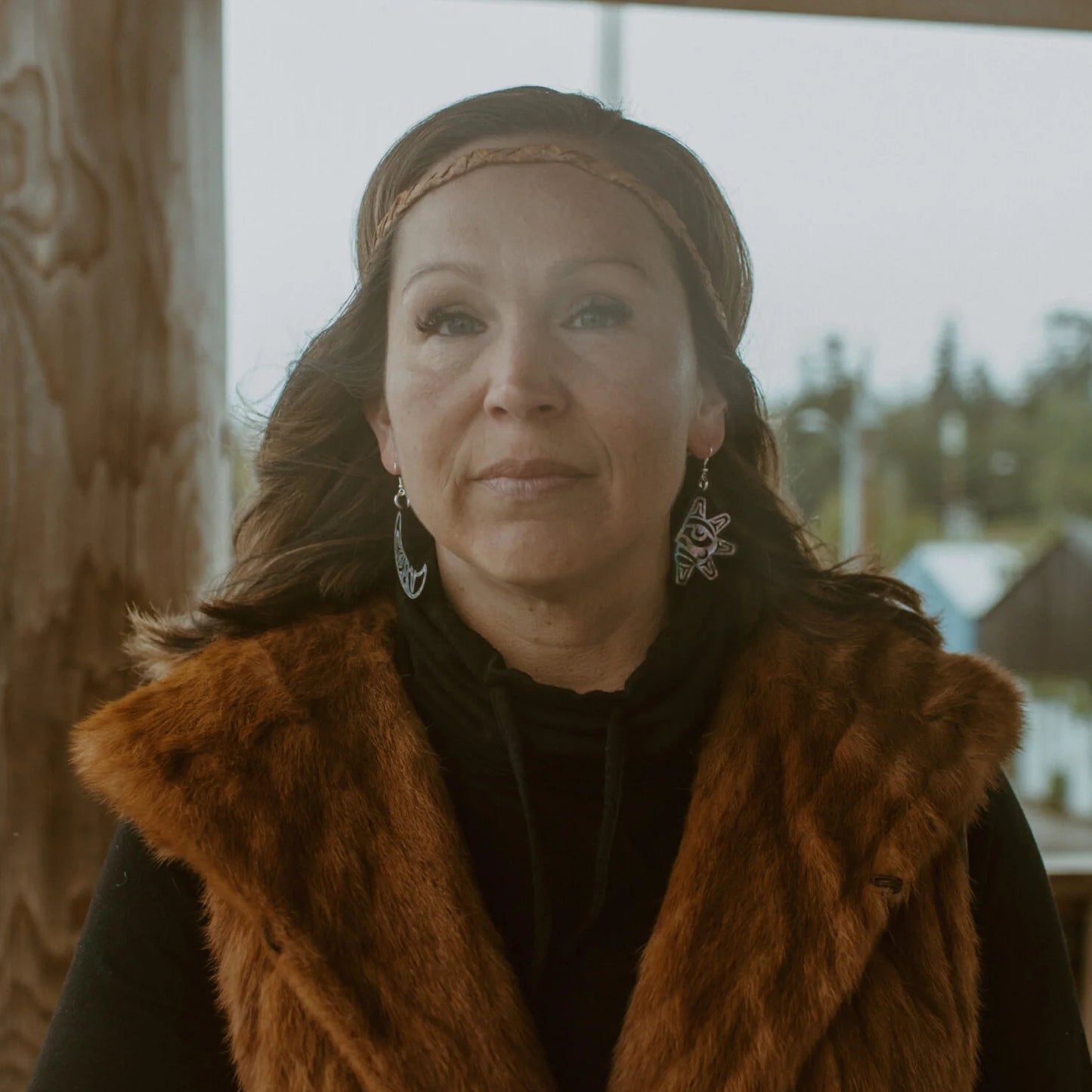 A wearing "Hupal" sun and moon earrings from Copper Canoe Woman.
