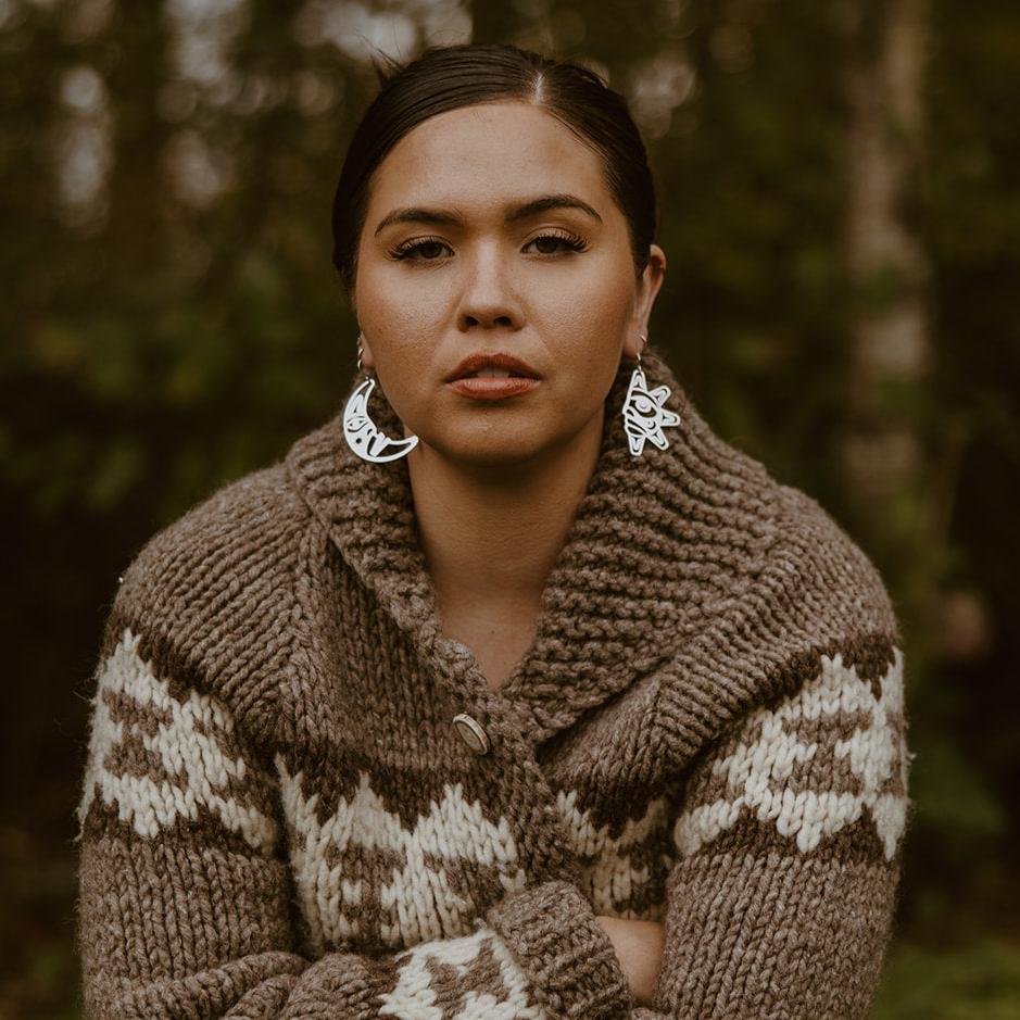 woman wearing sterling silver sun and moon with formline art cut outs from copper canoe woman