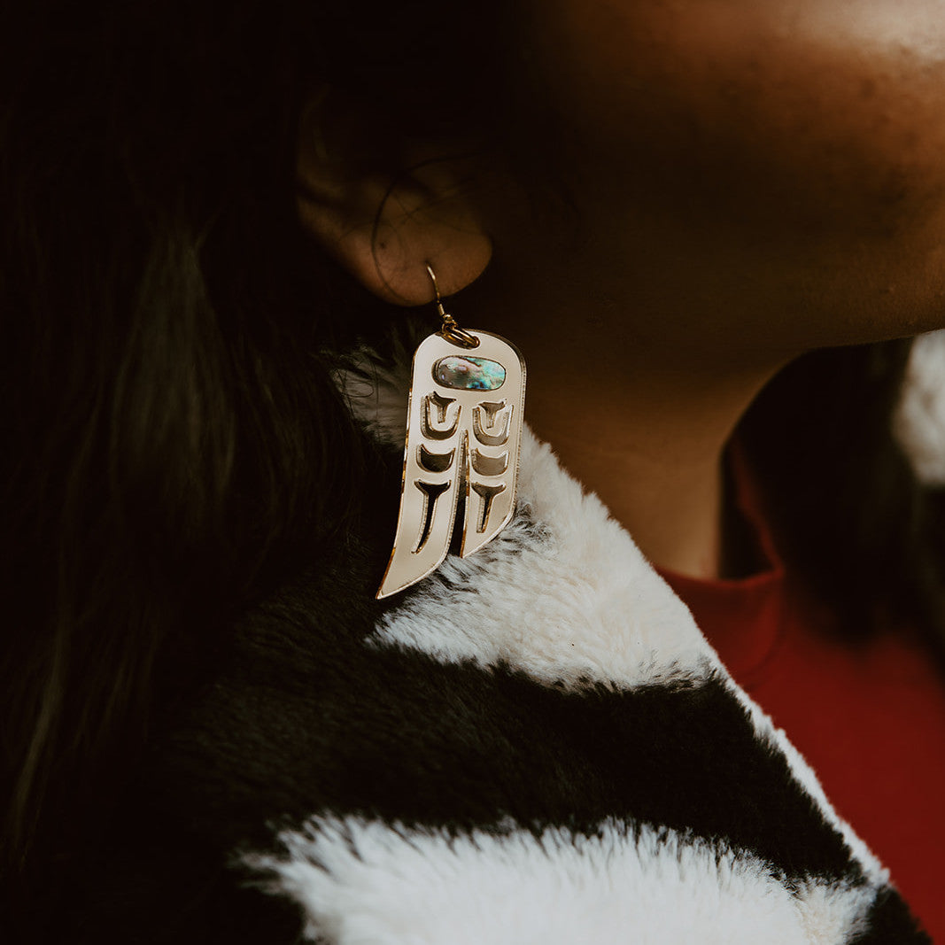 Gold mirror acrylic "Love Birds" earrings worn by a model from Copper Canoe Woman.