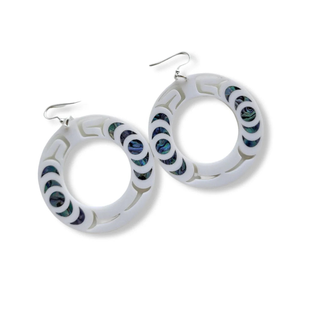 A pair of white acrylic "Nala Hoop" earrings from Copper Canoe Woman.