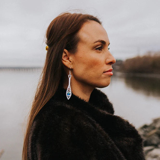 Profile of a woman wearing silver mirror acrylic "Paddle Song" earrings from Copper Canoe Woman.