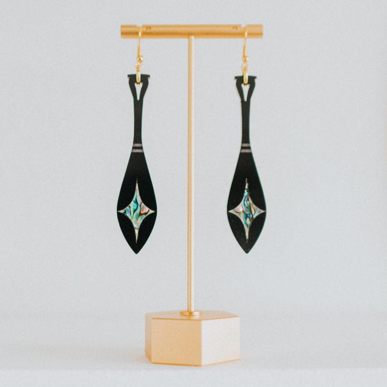 black acrylic paddle earring with star abalone inlay from copper canoe woman