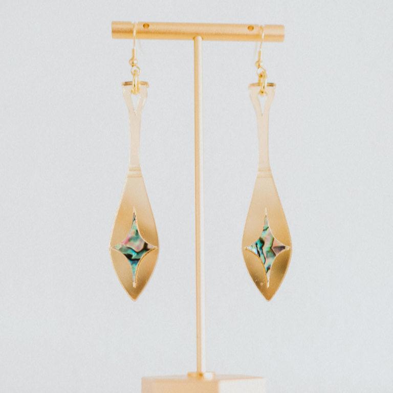 gold mirror acrylic paddle earring with star abalone inlay from copper canoe woman