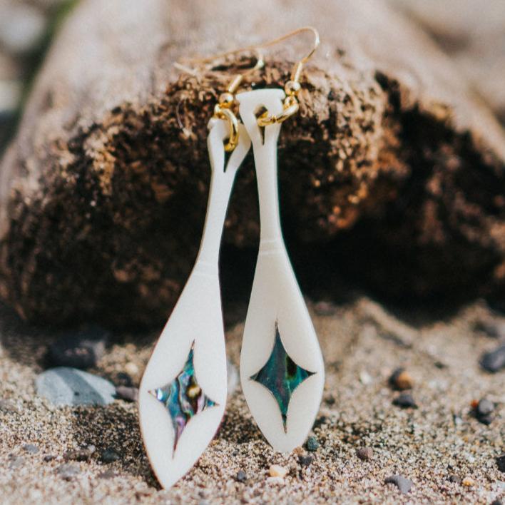 ivory acrylic paddle earring with star abalone inlay from copper canoe woman