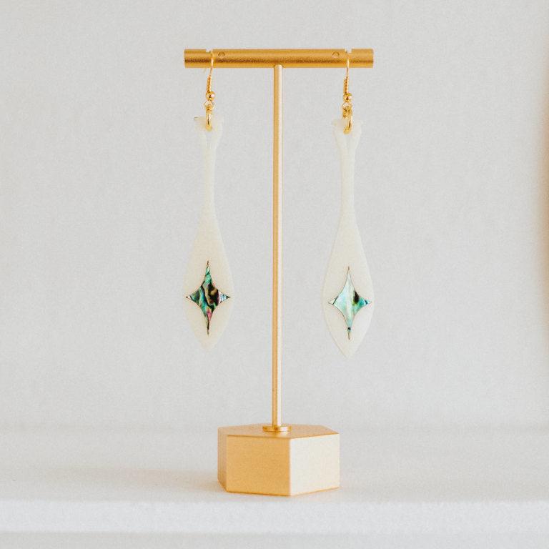 ivory acrylic paddle earring with star abalone inlay from copper canoe woman