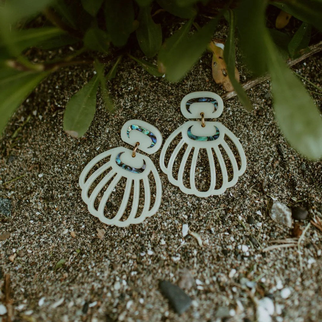 A pair of "Shell Woman" earrings from Copper Canoe woman in ivory acrylic.