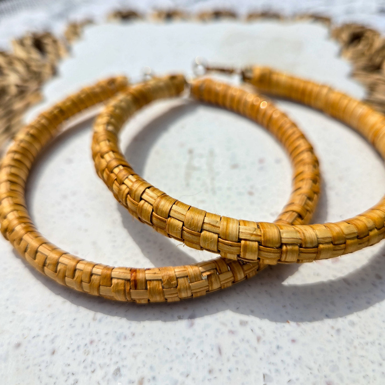Women wearing earthline cedar woven hoop earring