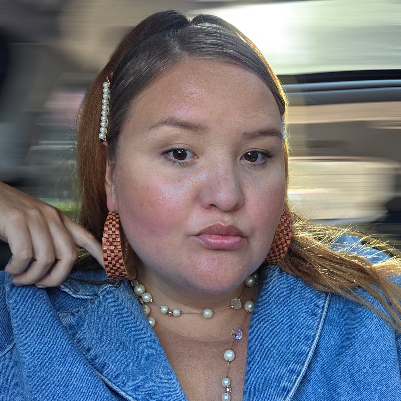 Women Wearing Woven rattan hoop earrings.