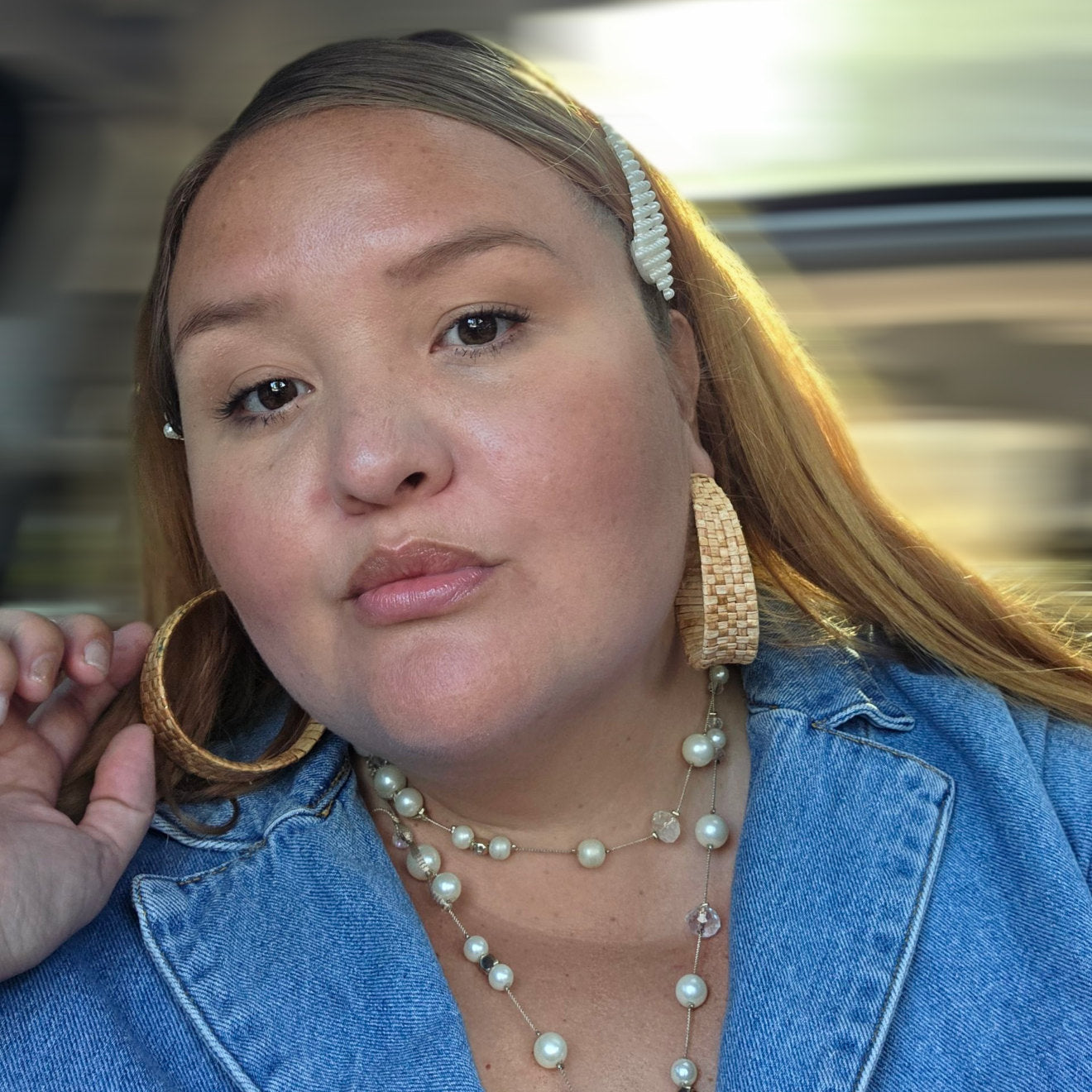 Women wearing Woven rattan hoop earrings. Thick, tapered design.