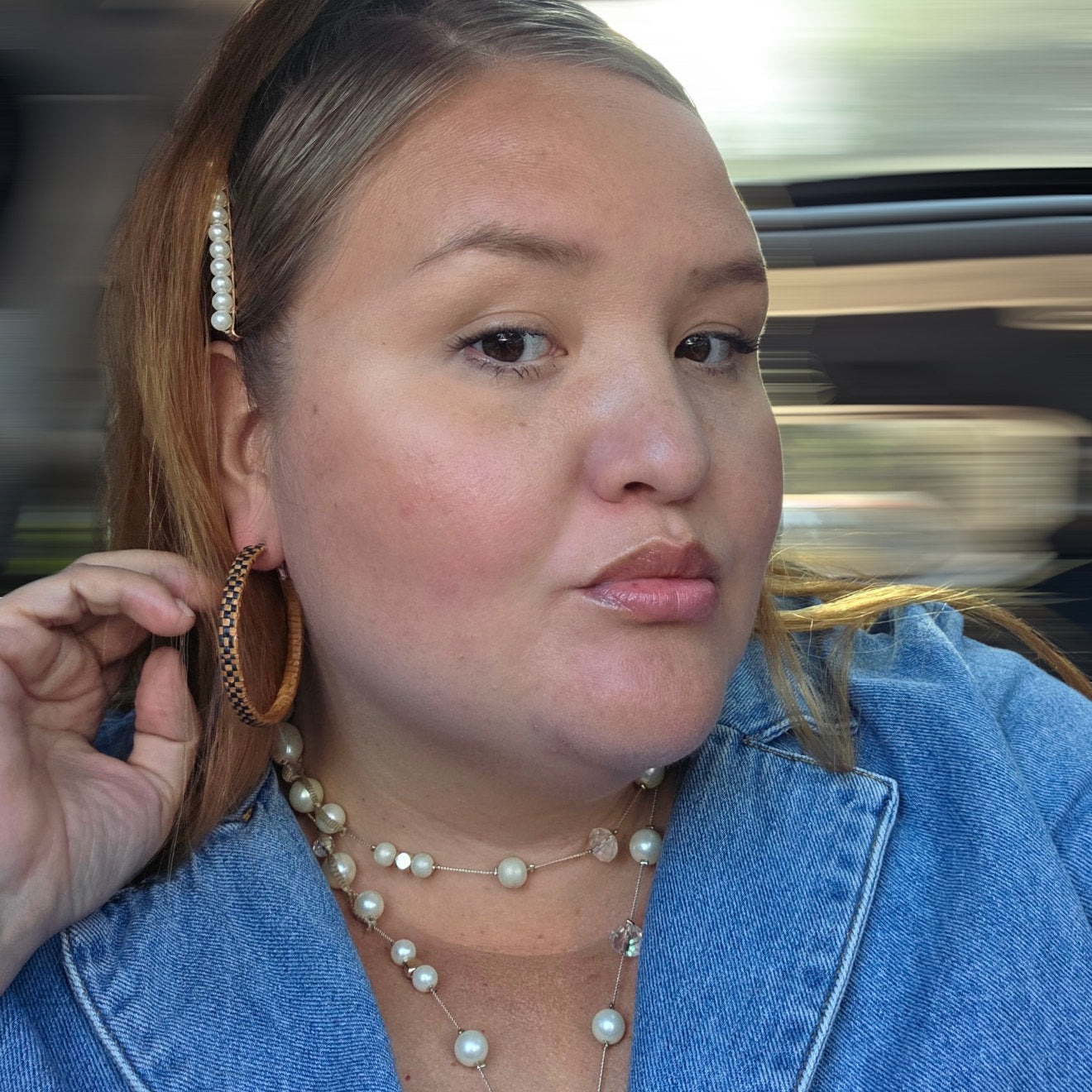 women wearing Pair of woven hoop earrings with red and black checkered pattern.