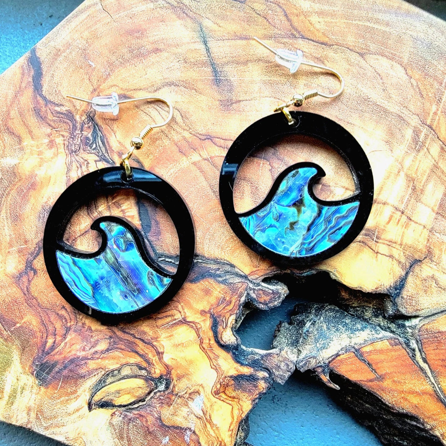 black acrylic earring with wave cut out and abalone inlay from copper canoe woman