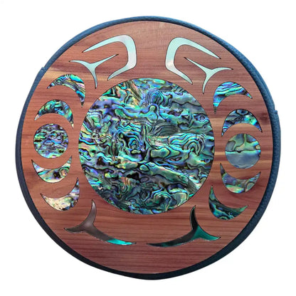 Decorative wall art with abalone shell inlay on a wooden circle