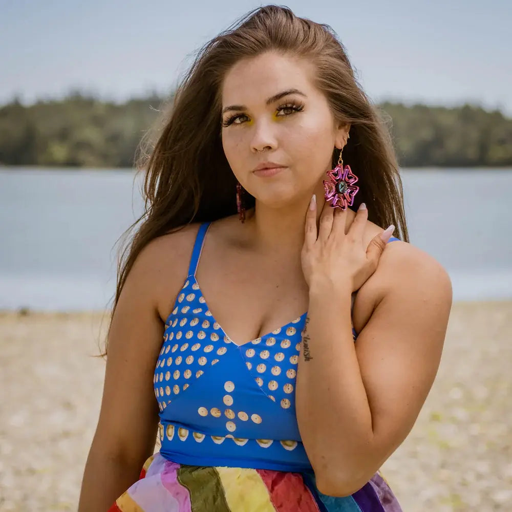 Sam from Copper Canoe Woman team displaying jewelry pieces