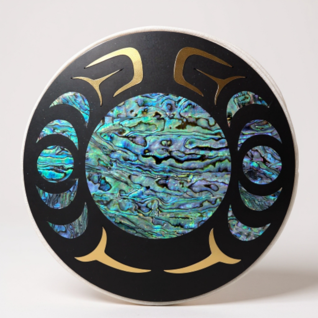 Decorative plate with abalone shell inlay and gold accents on a white background
