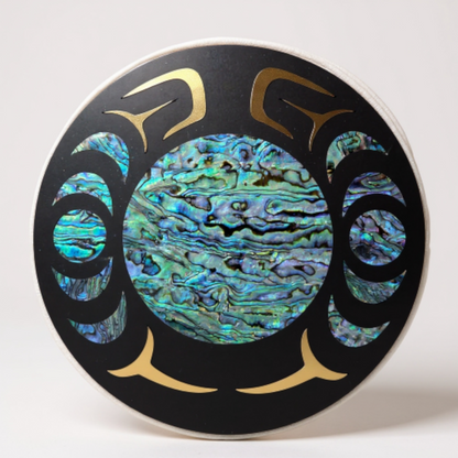 Decorative plate with abalone shell inlay and gold accents on a white background