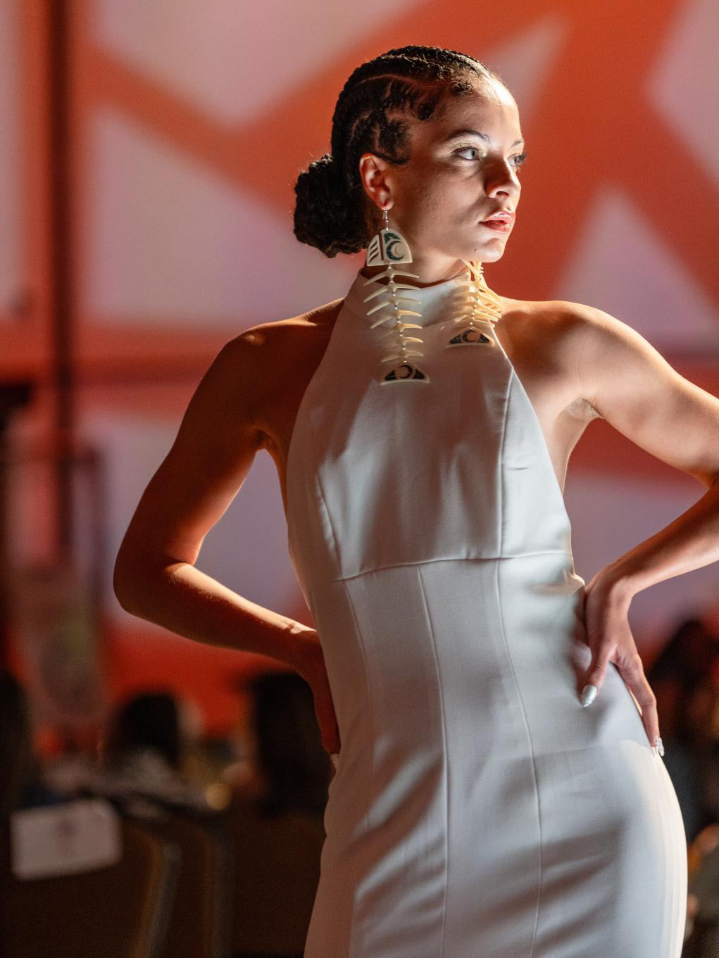 Woman in a white dress and salmon ghost earrings