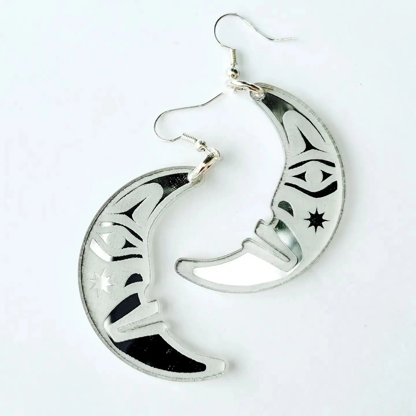 silver acrylic crescent moon engraved with formline art from copper canoe woman