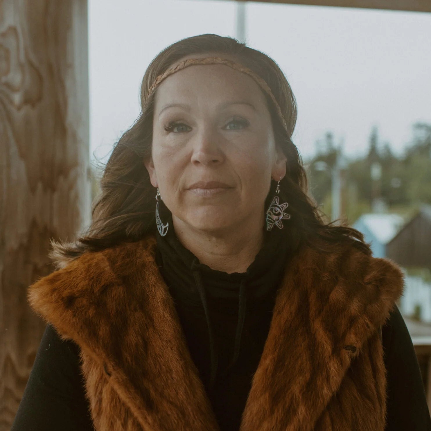 A wearing "Hupal" sun and moon earrings from Copper Canoe Woman.