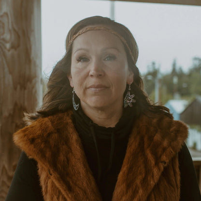 A wearing "Hupal" sun and moon earrings from Copper Canoe Woman.