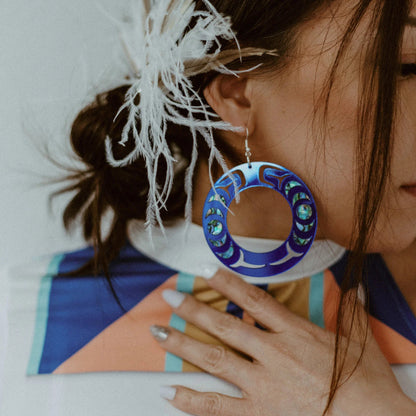 Closeup of model wearing the cobalt mirror acrylic "Nala Hoop" earrings from Copper Canoe Woman.