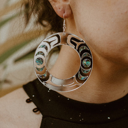Closeup of model wearing the silver mirror acrylic "Nala Hoop" earrings from Copper Canoe Woman.