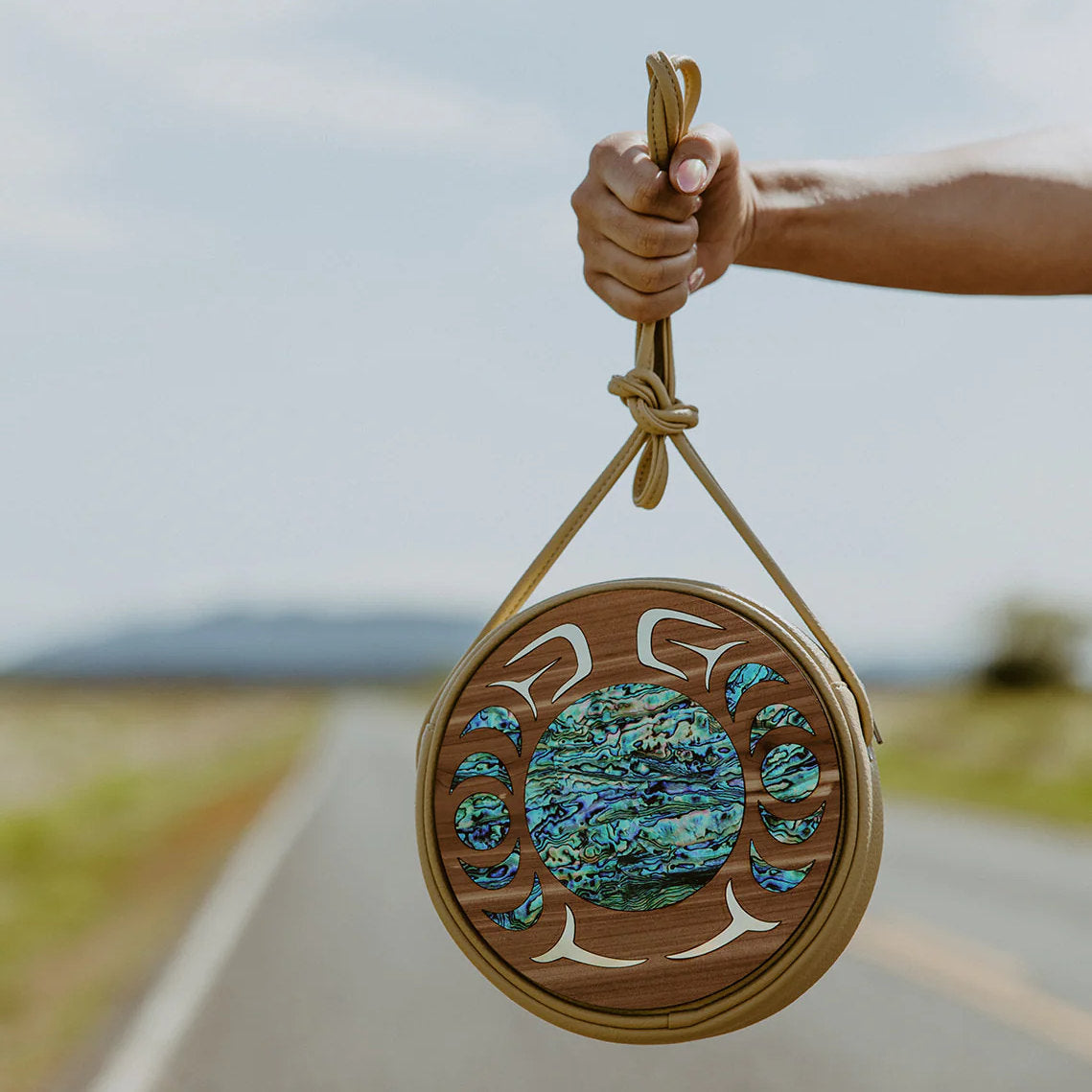 Hand holding round READY TO SHIP abalone shell purse