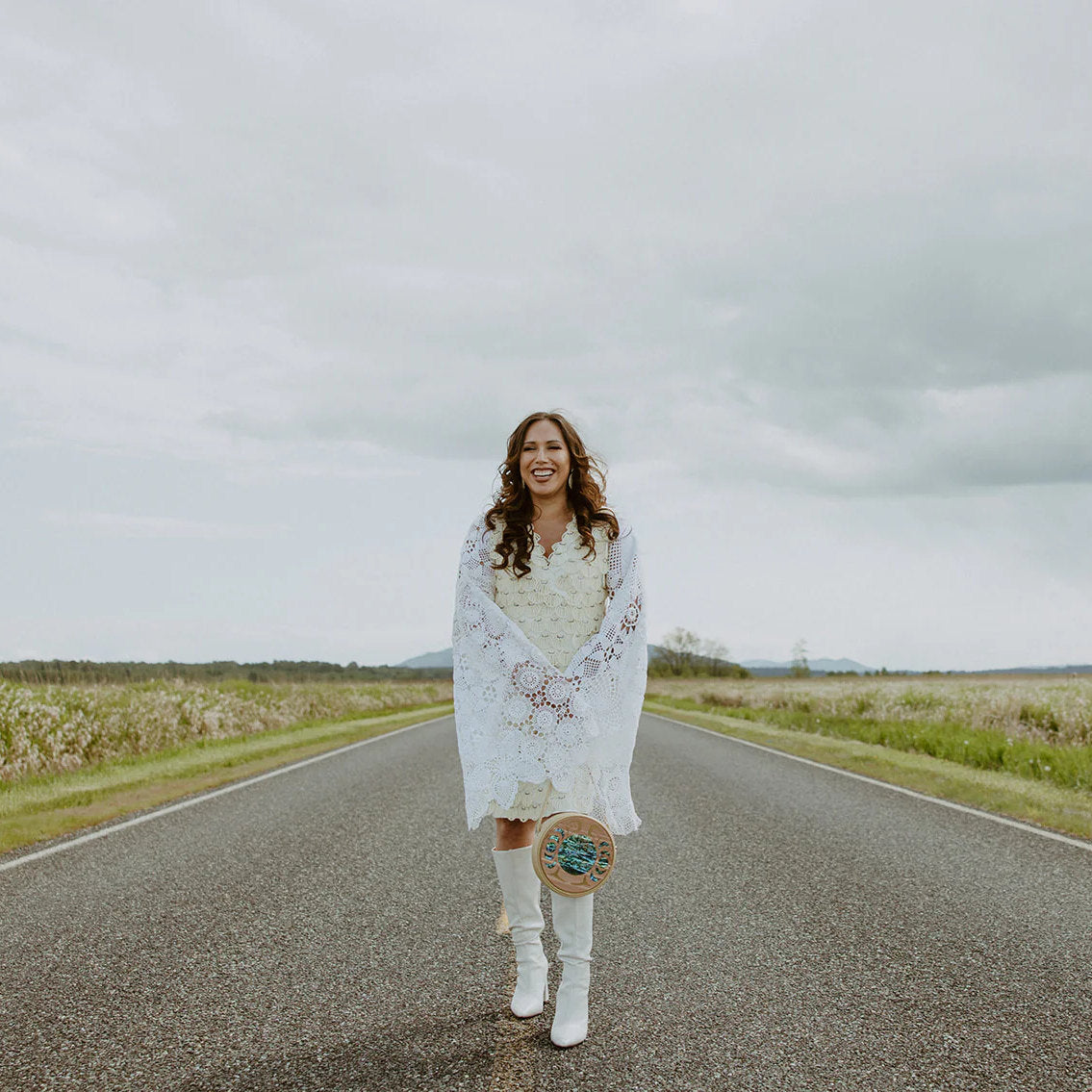 Woman in boots holding READY TO SHIP purse outdoors