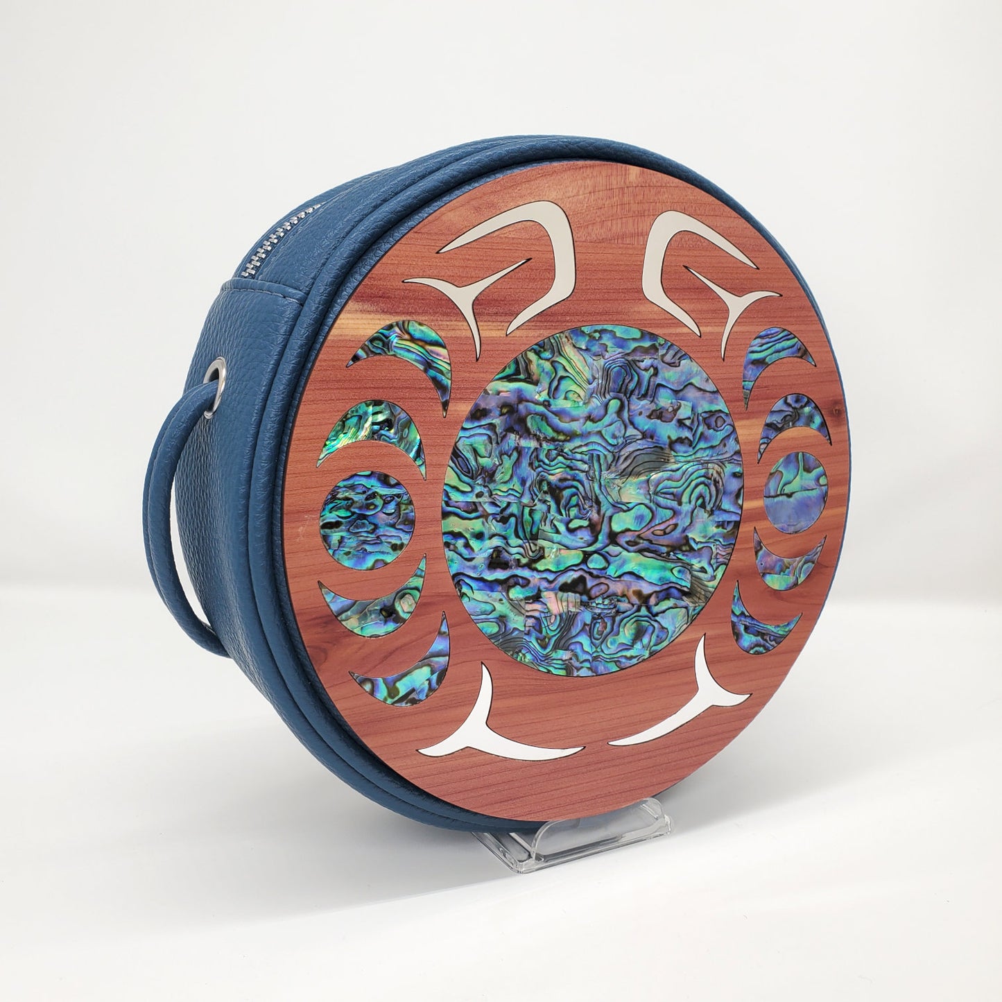 Blue faux leather circular handbag with cedar wood nala design in abalone and gold inlay from Copper Canoe Woman.