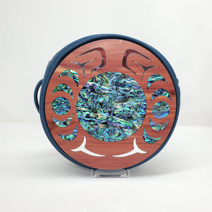 Blue faux leather handbag with circular cedar wood nala design from Copper Canoe Woman and abalone and gold inlay .