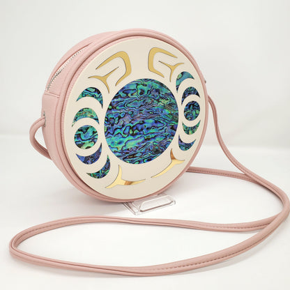 Round pink handbag with Copper Canoe Woman Nala design and abalone and gold inlay.