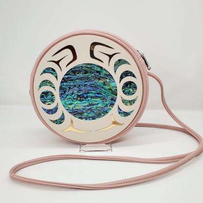 Round pink handbag with circular Nala design and abalone and gold inlay from Copper Canoe Woman.