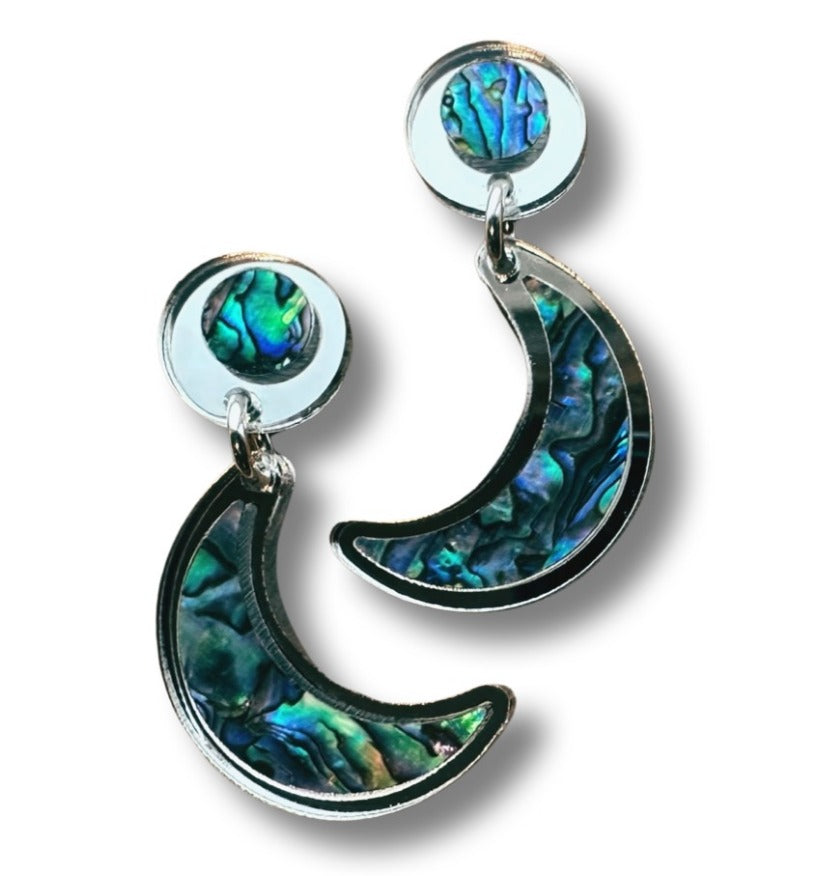 Silver mirror acrylic "Nuci" crescent moon post earrings from Copper Canoe Woman on a white background.