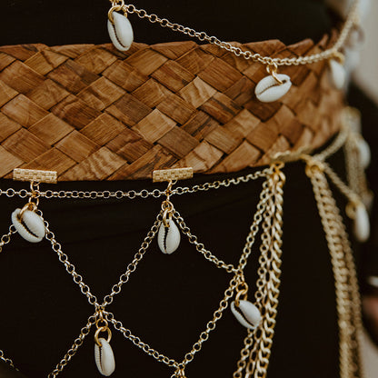 Belt with gold chains and shell decorations on a woven belt