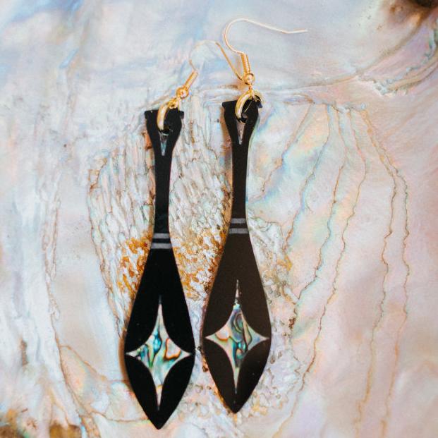 black acrylic paddle earring with star abalone inlay from copper canoe woman