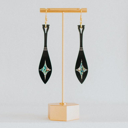 black acrylic paddle earring with star abalone inlay from copper canoe woman