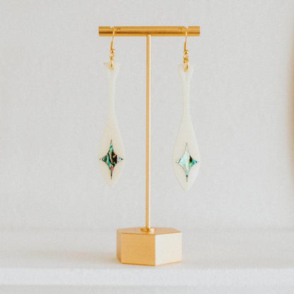 ivory acrylic paddle earring with star abalone inlay from copper canoe woman