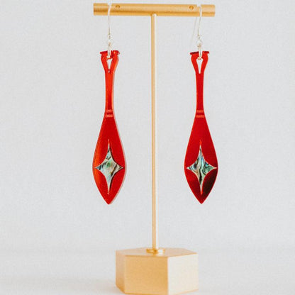 red mirror acrylic paddle earring with star abalone inlay from copper canoe woman