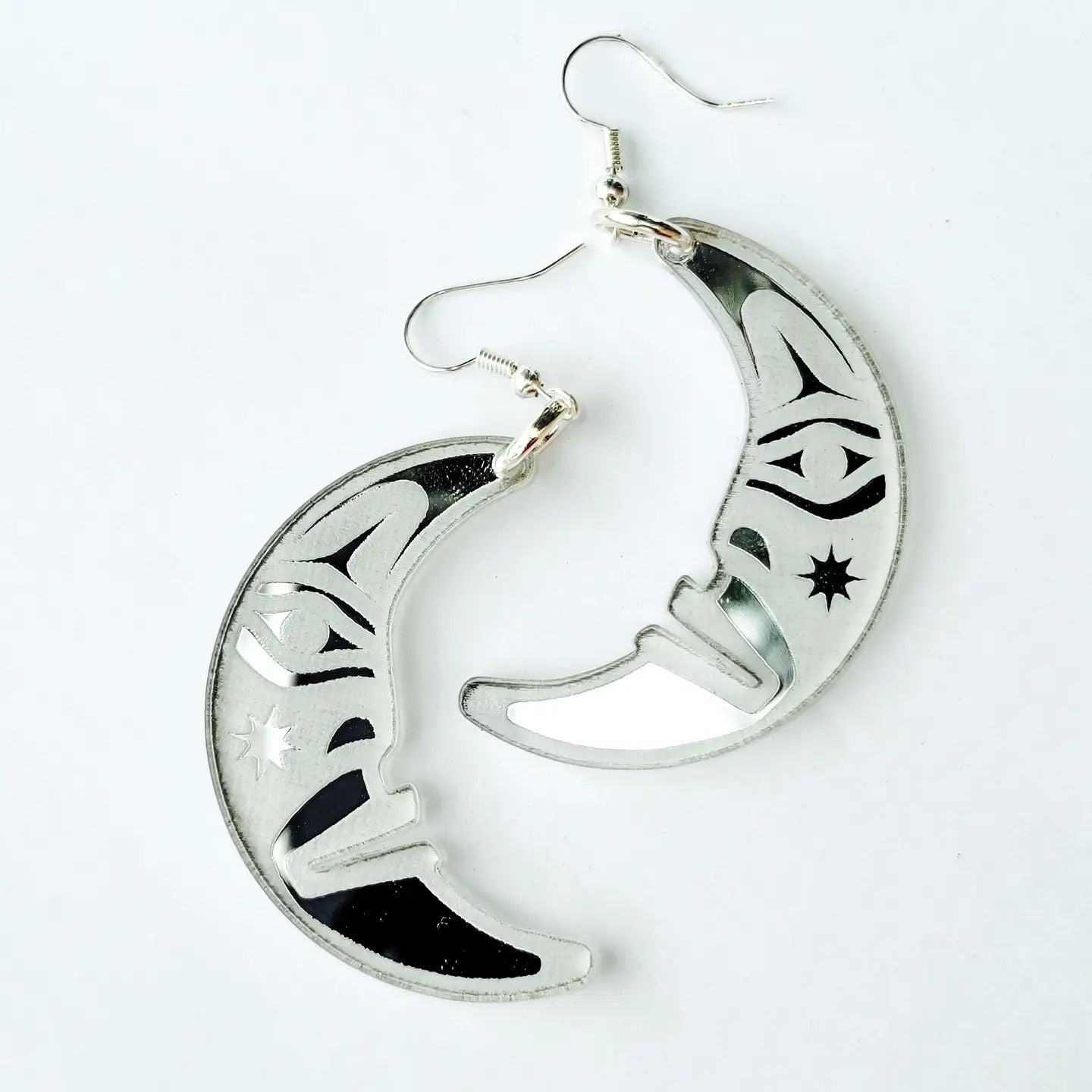 silver acrylic crescent moon engraved with formline art from copper canoe woman