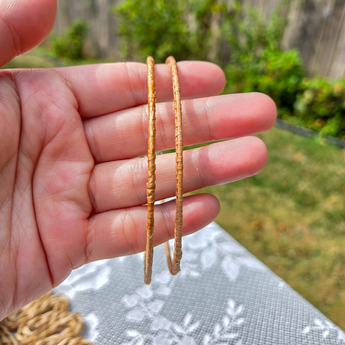 earthline cedar woven hoop earring thick band showing in hand