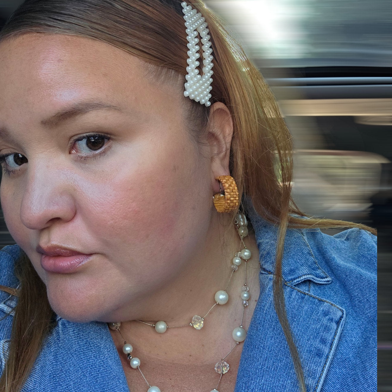 Model with head tilted to show a hand-woven clip-on hoop earring made of cedar from Copper Canoe Woman.