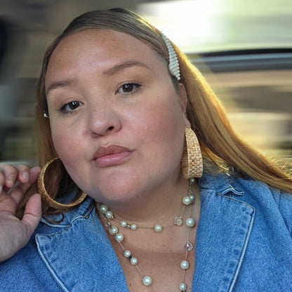 Women wearing Woven rattan hoop earrings. Thick, tapered design.